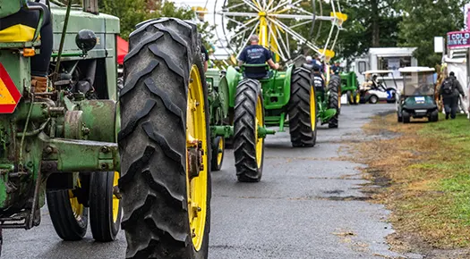 Tractors in line going through the fair grounds