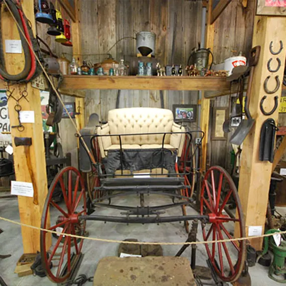 Display of antique items including an old carriage