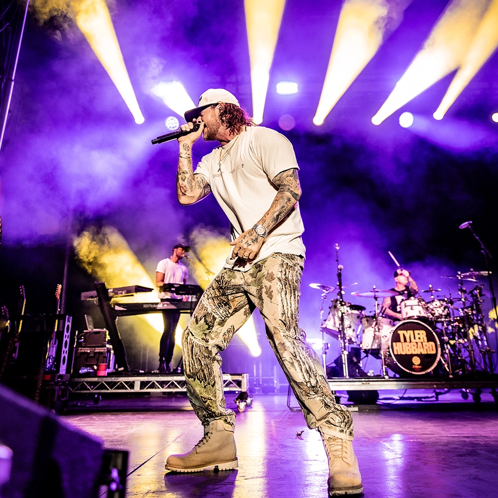 Tyler Hubbard singing on stage during a concert